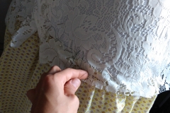 basting the lace down to the base-skirt prior to sewing it in-place